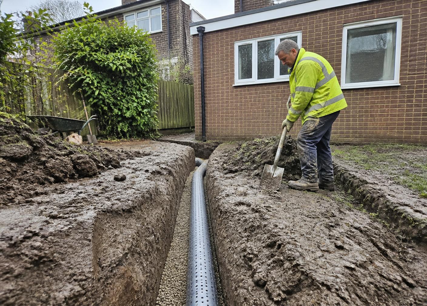Land drain installation in a Surrey garden